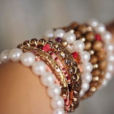 Girl's hand with multiple bracelets